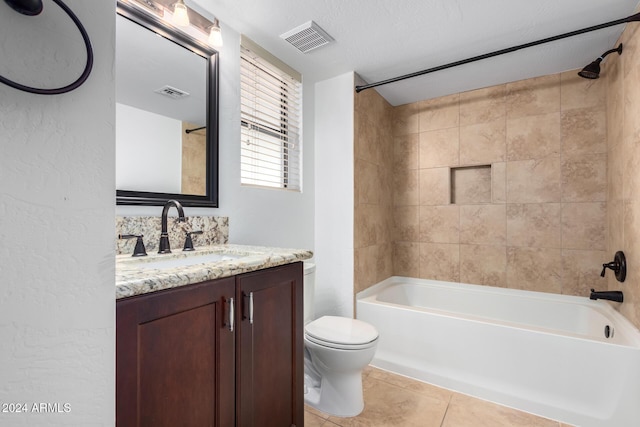 full bathroom featuring tiled shower / bath combo, tile patterned flooring, a textured ceiling, toilet, and vanity