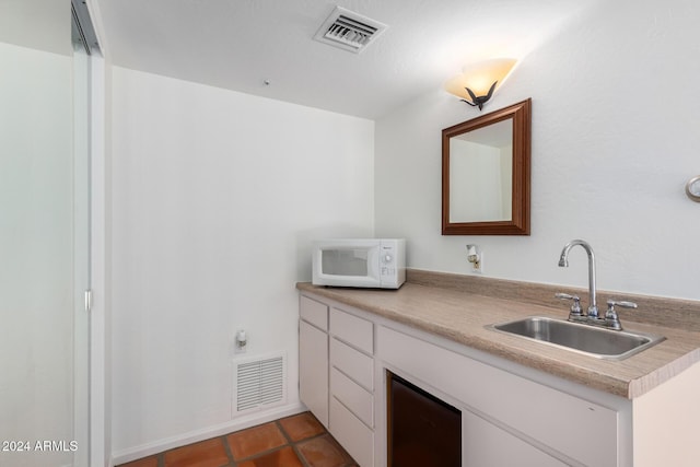 bathroom featuring sink and tile patterned flooring