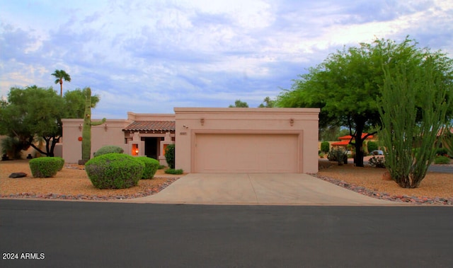 pueblo revival-style home with a garage