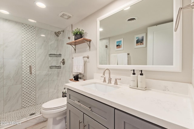 bathroom featuring vanity, an enclosed shower, and toilet