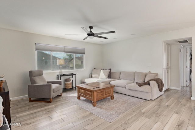 living room featuring ceiling fan and light hardwood / wood-style flooring