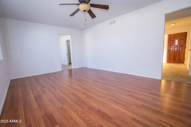 unfurnished room with ceiling fan and hardwood / wood-style floors