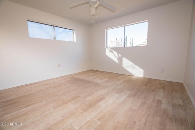 unfurnished room featuring light wood-type flooring and ceiling fan