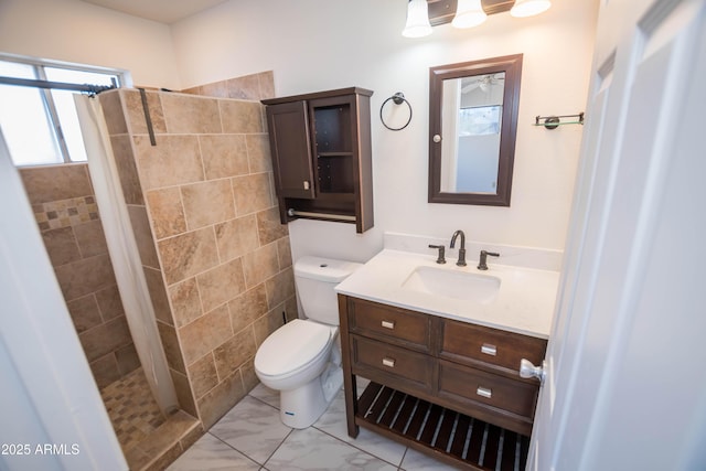 bathroom featuring a shower with shower curtain, vanity, and toilet