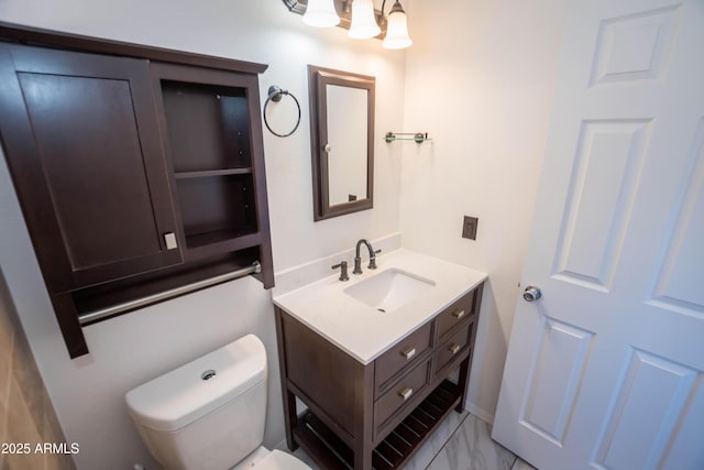 bathroom featuring toilet and vanity