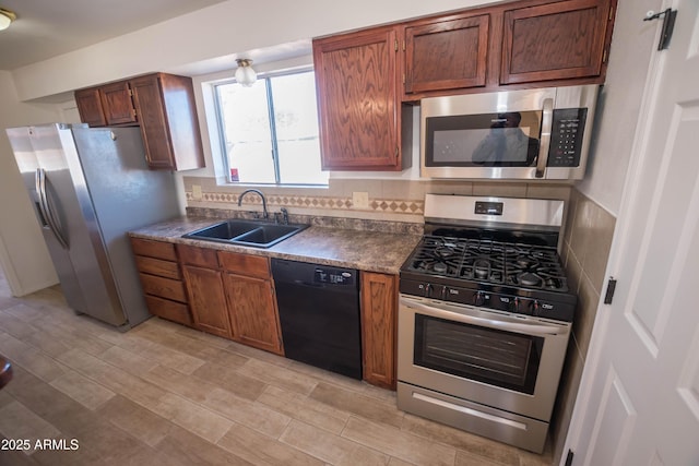 kitchen featuring appliances with stainless steel finishes, tasteful backsplash, and sink