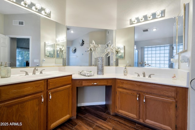 bathroom featuring visible vents, a sink, and wood finished floors