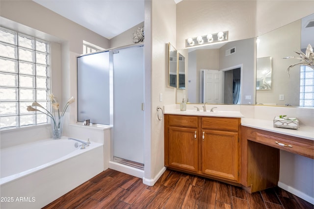 bathroom with a stall shower, vanity, visible vents, and wood tiled floor