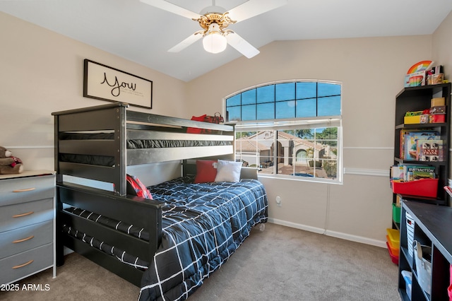 carpeted bedroom featuring lofted ceiling, a ceiling fan, and baseboards