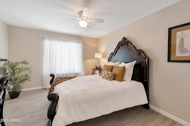 bedroom with baseboards, ceiling fan, and wood tiled floor