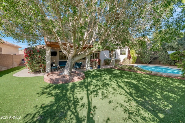 view of yard with a patio area, a fenced backyard, and a fenced in pool