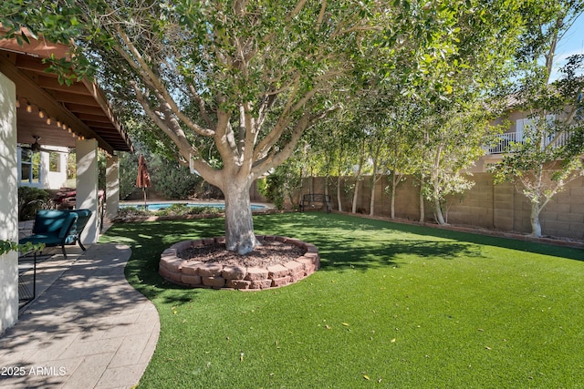 view of yard with a fenced backyard and a swimming pool