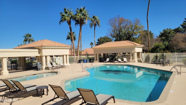 pool featuring a gazebo, a patio area, and fence