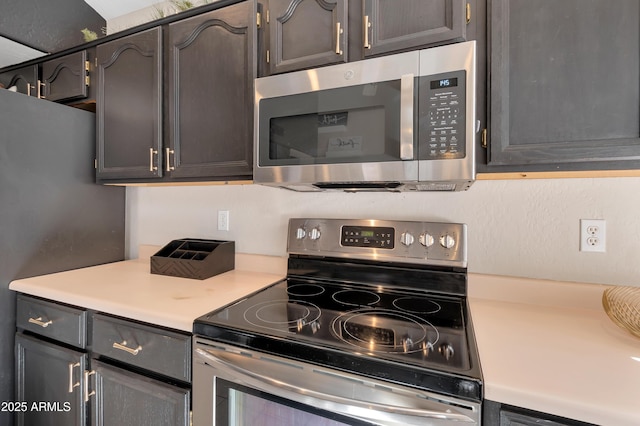 kitchen with appliances with stainless steel finishes and light countertops