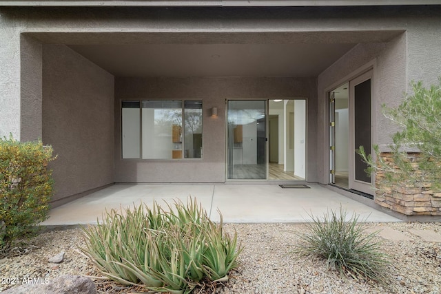 property entrance featuring a patio area