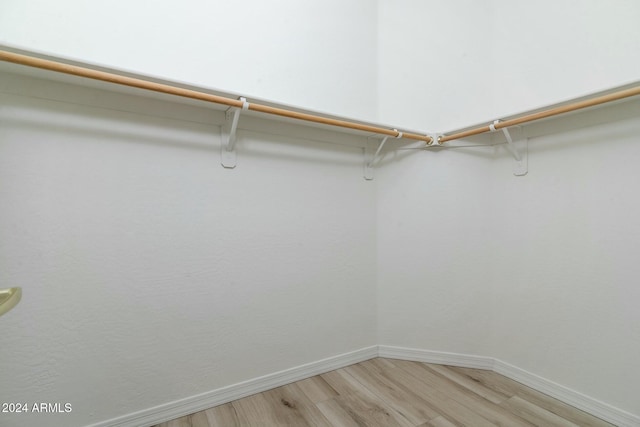 walk in closet with wood-type flooring