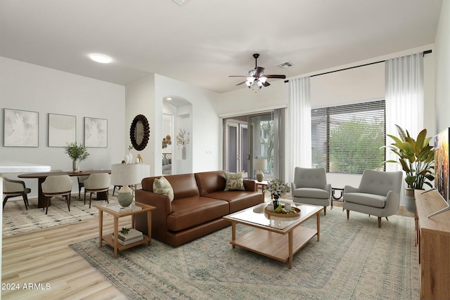 living room with wood-type flooring and ceiling fan