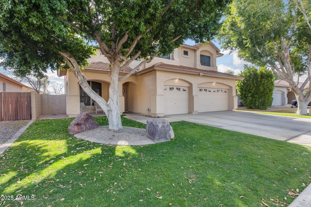 view of front of property featuring a garage and a front yard