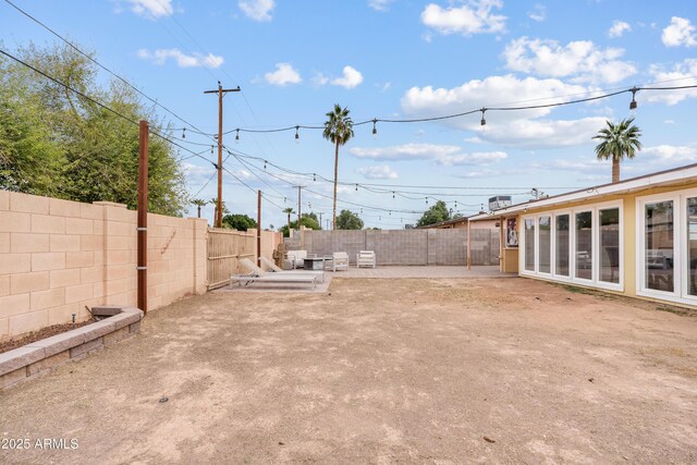 view of yard featuring a patio area and a fenced backyard