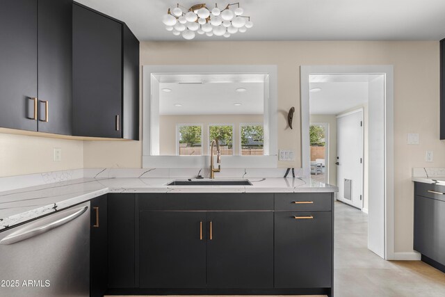 kitchen featuring dishwasher, a sink, light stone countertops, and dark cabinets