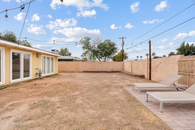 view of yard featuring a patio area and a fenced backyard