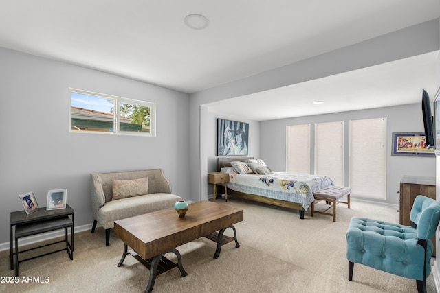 bedroom featuring light colored carpet and baseboards