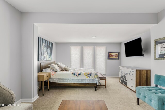 bedroom with carpet flooring and baseboards