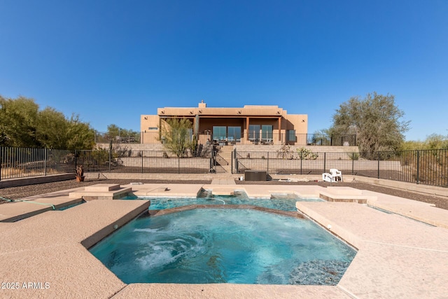 view of swimming pool with an in ground hot tub