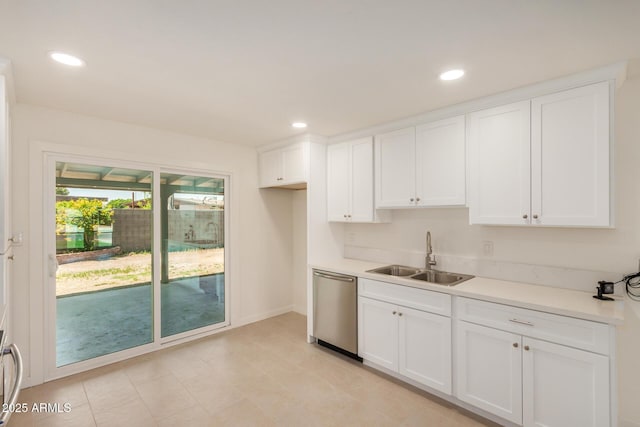 kitchen featuring a sink, dishwasher, white cabinets, and light countertops