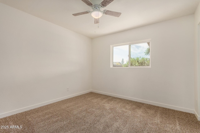 empty room with light colored carpet, a ceiling fan, and baseboards