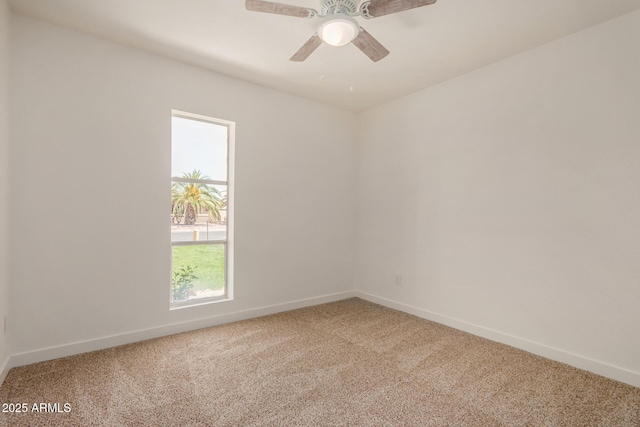 empty room featuring baseboards, ceiling fan, and carpet