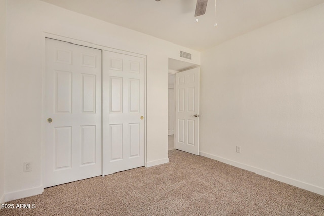 unfurnished bedroom with a ceiling fan, visible vents, baseboards, a closet, and carpet flooring