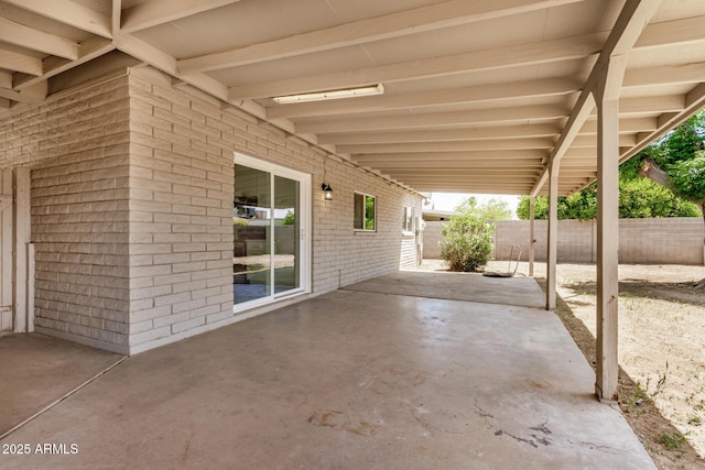 view of patio featuring fence