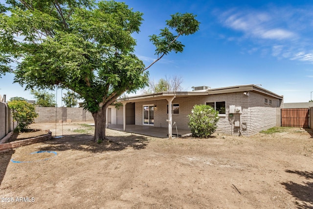 back of property featuring a fenced backyard and a patio