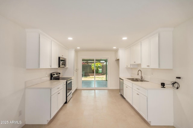 kitchen with light countertops, recessed lighting, appliances with stainless steel finishes, and a sink