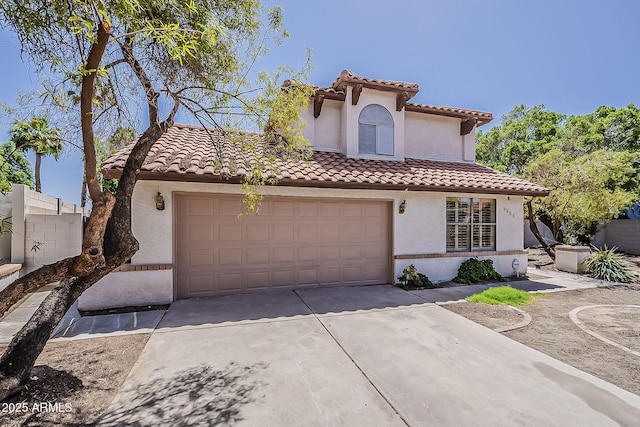 4627 E Mcneil St, Phoenix, AZ 85044 - mediterranean / spanish home featuring concrete driveway, a tile roof, a garage, and stucco siding