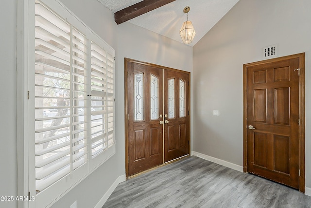 4627 E Mcneil St, Phoenix, AZ 85044 - entryway featuring plenty of natural light, wood finished floors, baseboards, beamed ceiling, and high vaulted ceiling