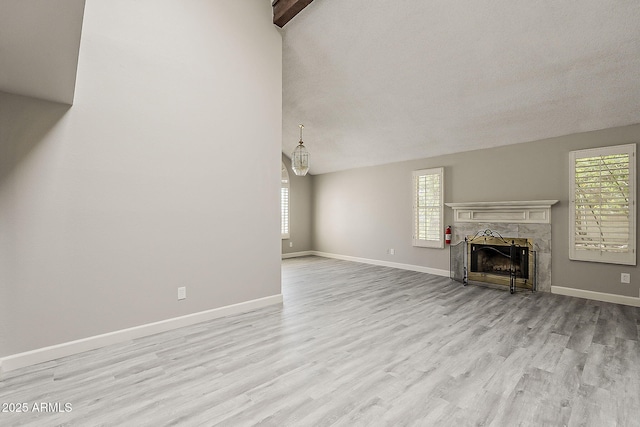 4627 E Mcneil St, Phoenix, AZ 85044 - unfurnished living room featuring healthy amount of natural light, wood finished floors, a fireplace, baseboards, and lofted ceiling