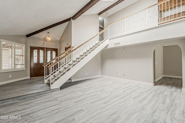 4627 E Mcneil St, Phoenix, AZ 85044 - foyer entrance with stairs, baseboards, arched walkways, beam ceiling, and wood finished floors