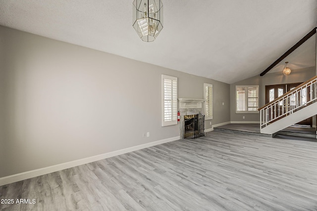 4627 E Mcneil St, Phoenix, AZ 85044 - unfurnished living room with stairway, wood finished floors, baseboards, and a fireplace
