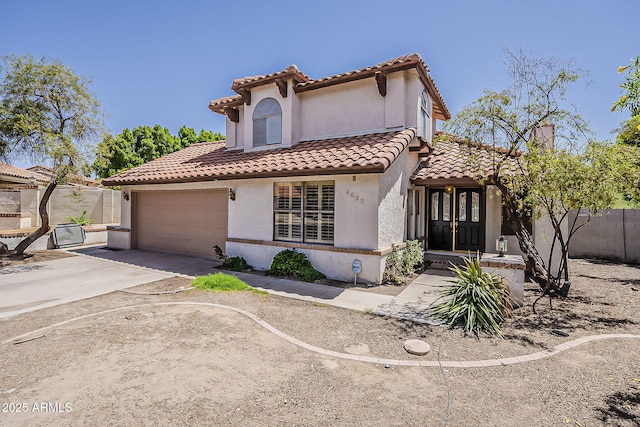 4627 E Mcneil St, Phoenix, AZ 85044 - mediterranean / spanish-style house with a tiled roof, stucco siding, driveway, fence, and an attached garage