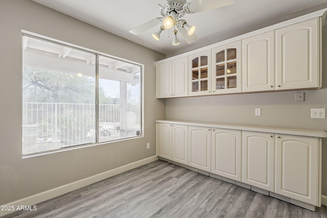 4627 E Mcneil St, Phoenix, AZ 85044 - unfurnished dining area with baseboards, light wood finished floors, and ceiling fan