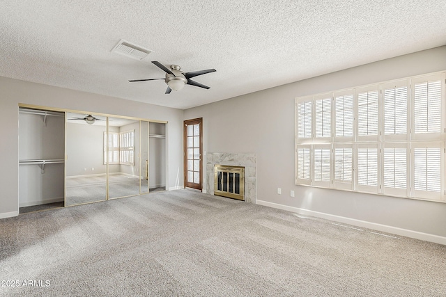 4627 E Mcneil St, Phoenix, AZ 85044 - unfurnished living room with a ceiling fan, baseboards, a textured ceiling, a high end fireplace, and carpet