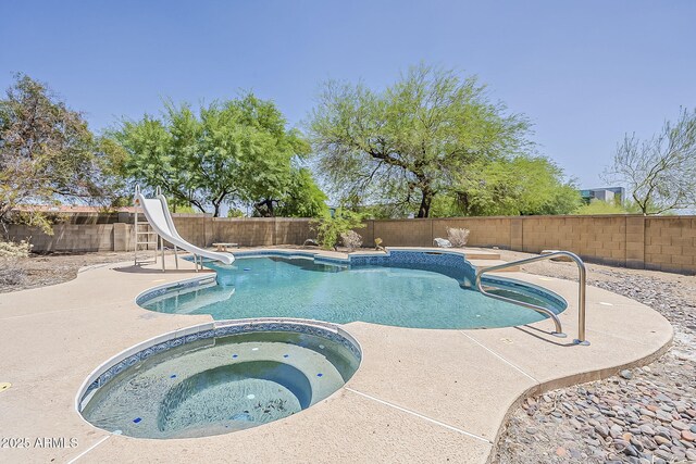 4627 E Mcneil St, Phoenix, AZ 85044 - view of swimming pool featuring a water slide, a fenced backyard, a pool with connected hot tub, and a patio