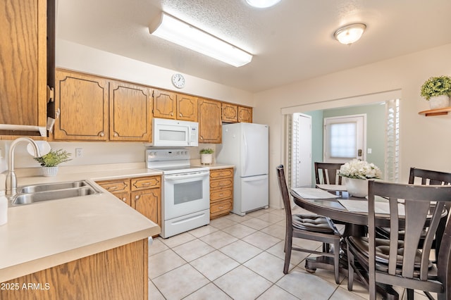 4501 E Carol Ave Unit 77, Mesa, AZ 85206 - kitchen featuring white appliances, a sink, light countertops, and light tile patterned floors