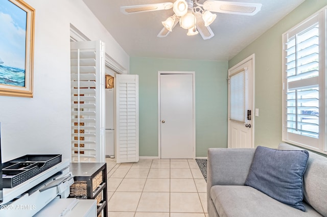 4501 E Carol Ave Unit 77, Mesa, AZ 85206 - living room with a ceiling fan, plenty of natural light, light tile patterned flooring, and baseboards