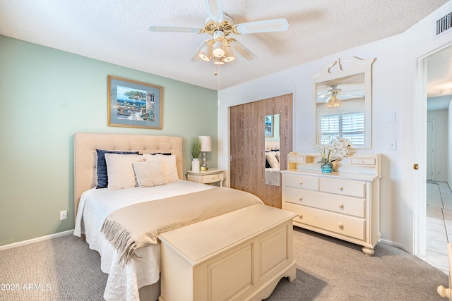 4501 E Carol Ave Unit 77, Mesa, AZ 85206 - bedroom featuring a textured ceiling, light carpet, ceiling fan, and baseboards