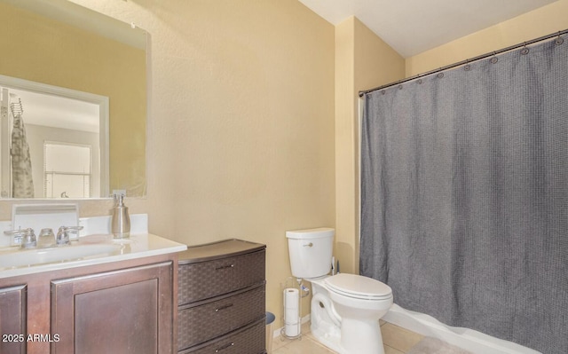 bathroom featuring vanity, tile patterned floors, and toilet