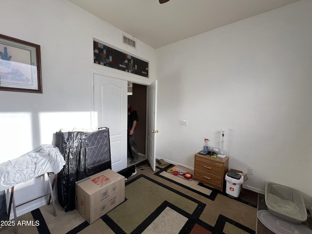 bedroom with baseboards and visible vents