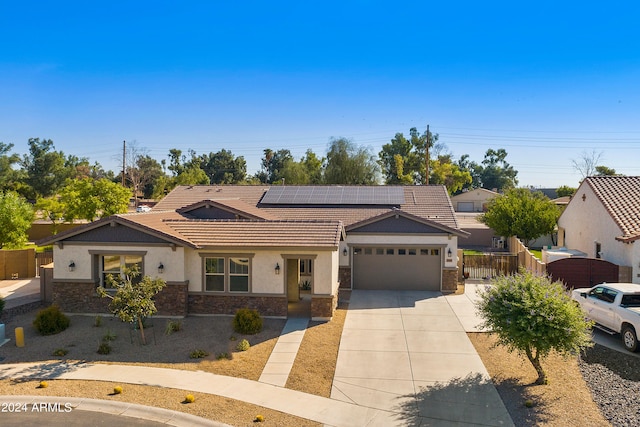 single story home featuring solar panels and a garage